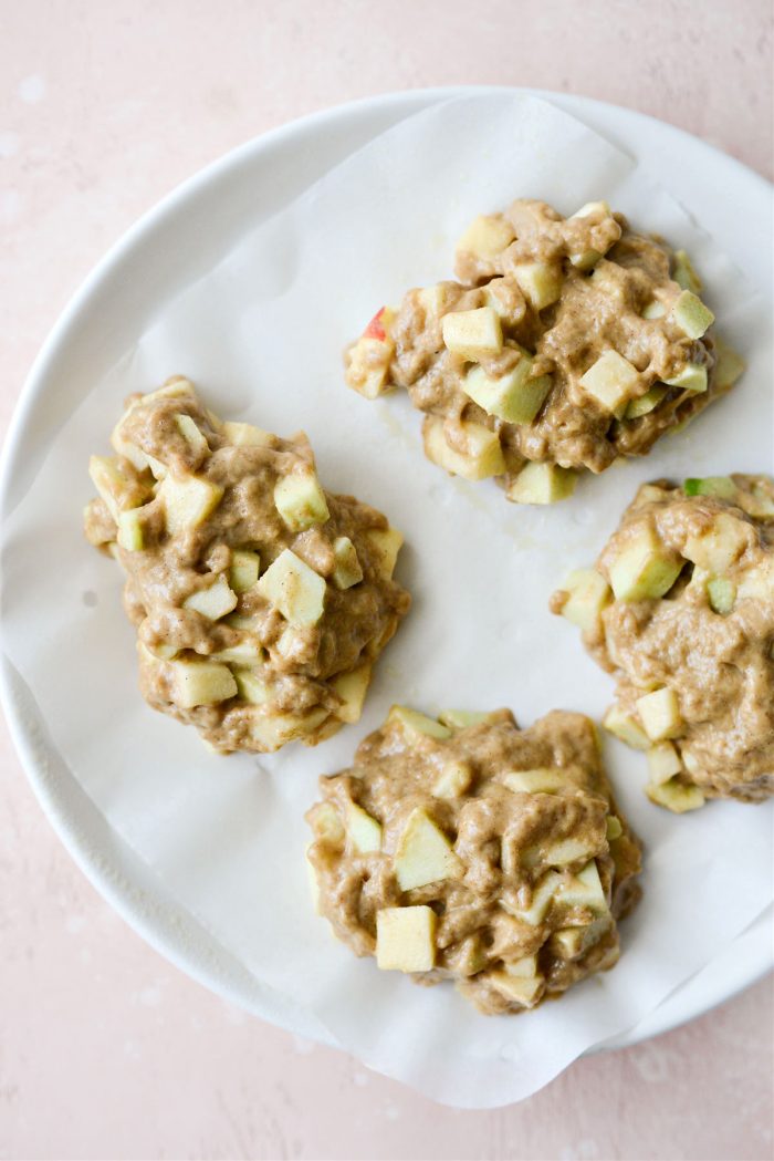 four mounds of batter on air fryer parchment paper on plate