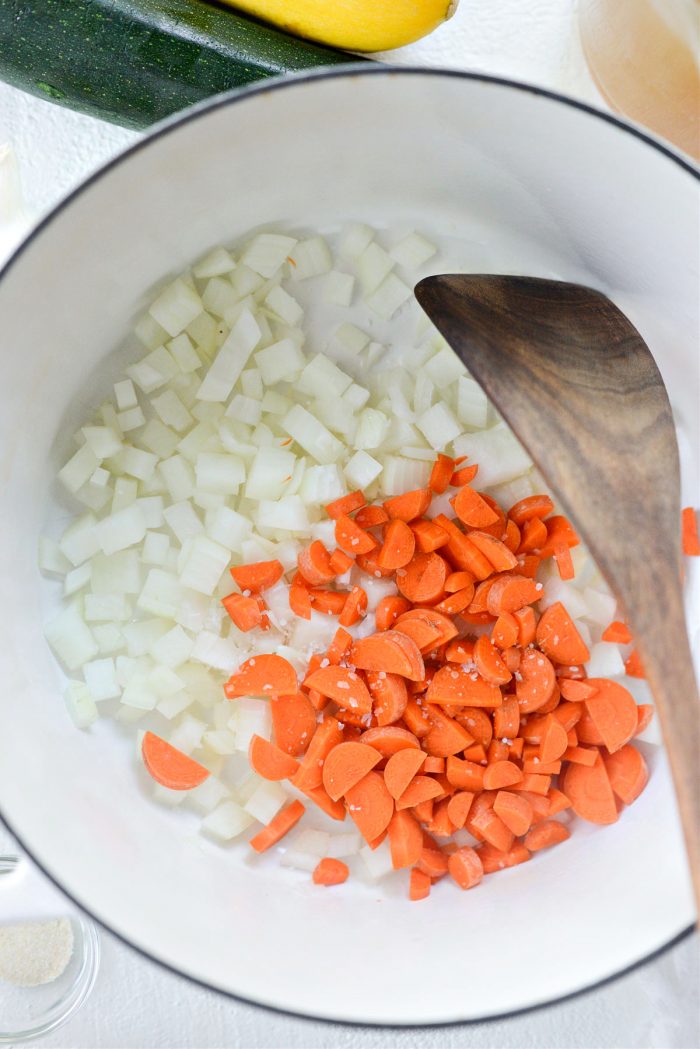 oil, onions and carrots in dutch oven