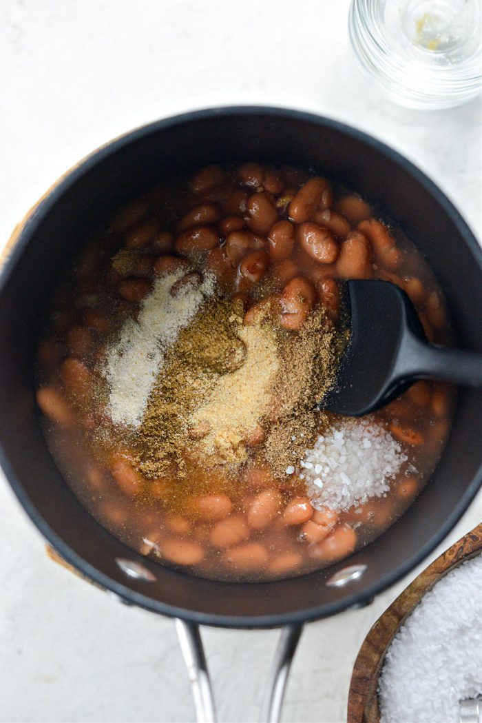 beans, some bean liquid and spices in pan or skillet