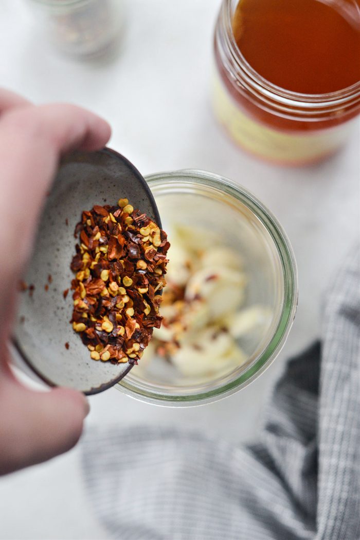 add red pepper flakes to jar with garlic