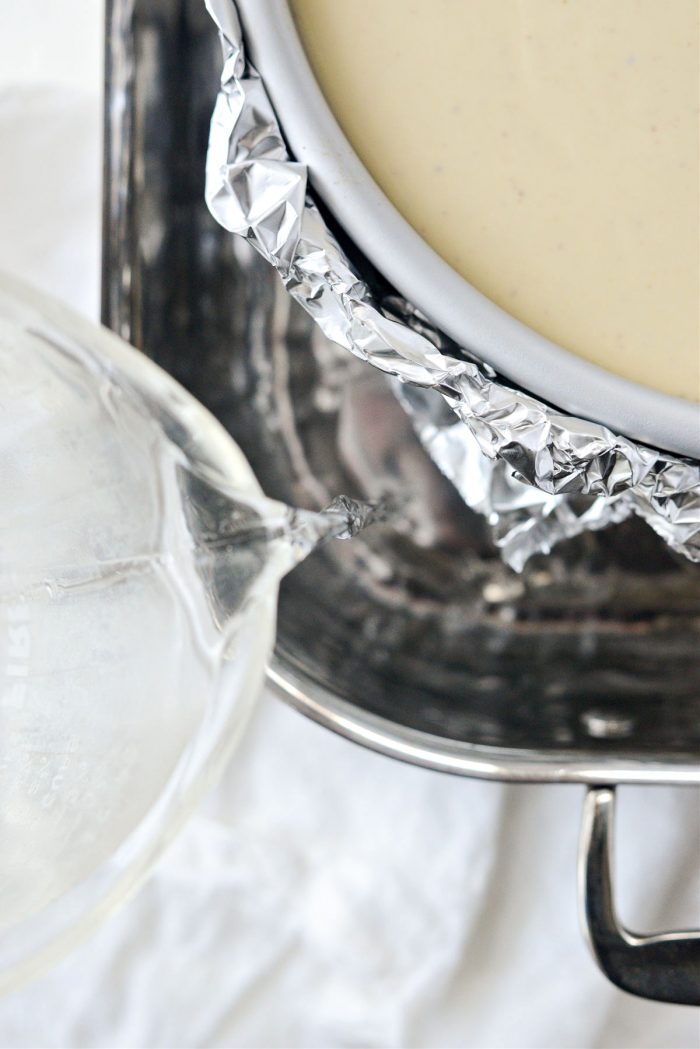 place foiled cheesecake in roasting pan and fill with water