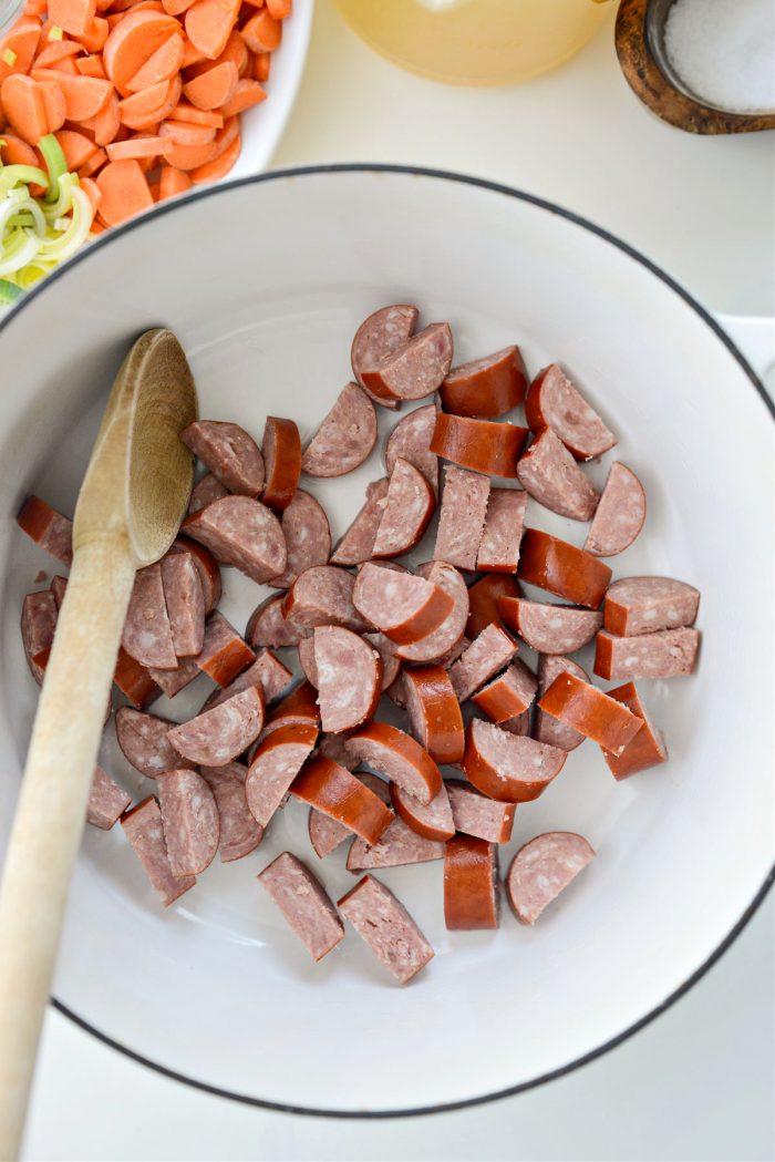 add olive oil and kielbasa to a dutch oven