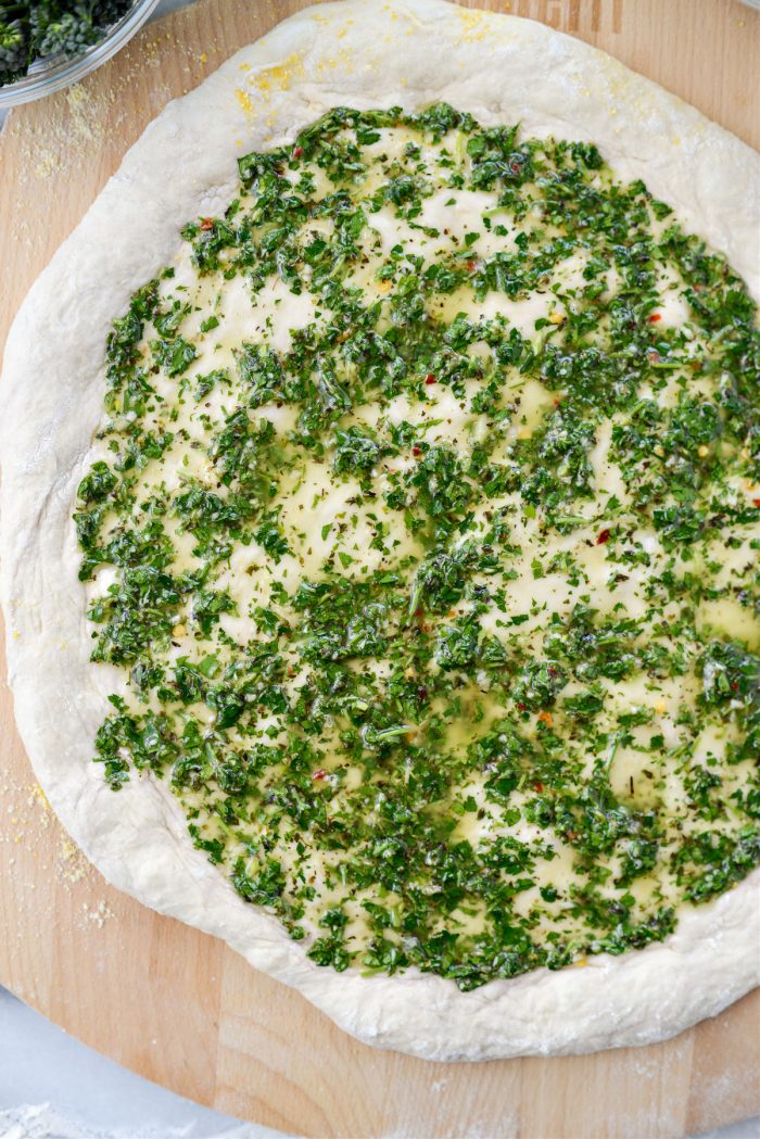 chimichurri spread over pizza dough