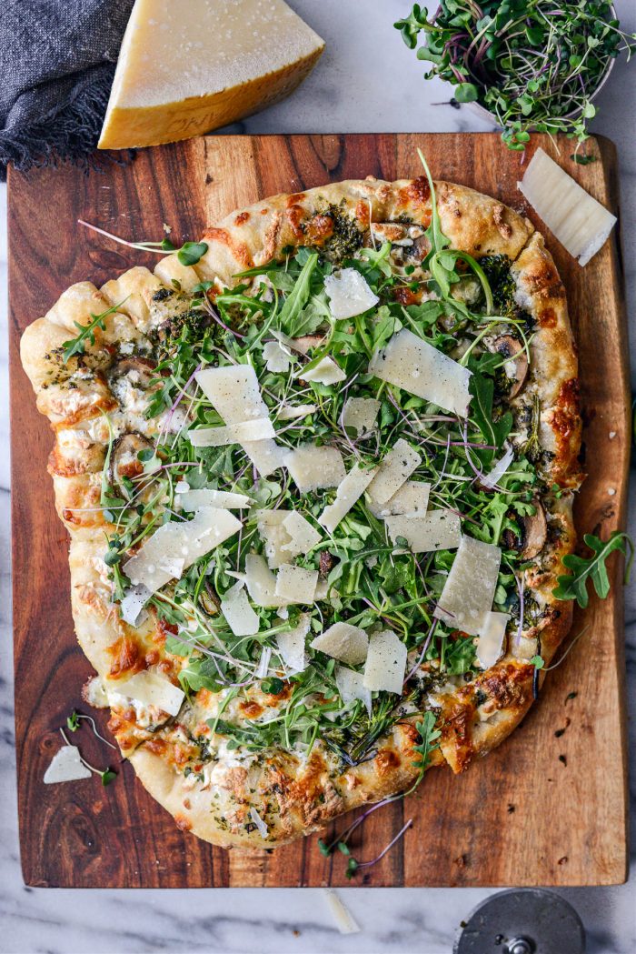 top with arugula, microgreens, parmesan shavings and black pepper