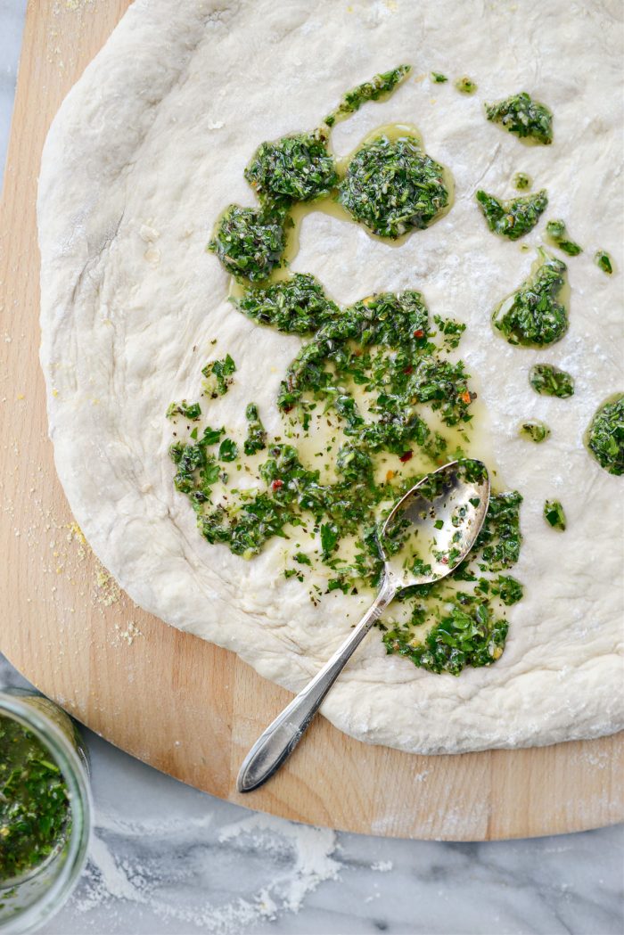 spread chimichurri on dough