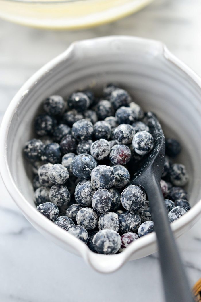 toss blueberries with flour