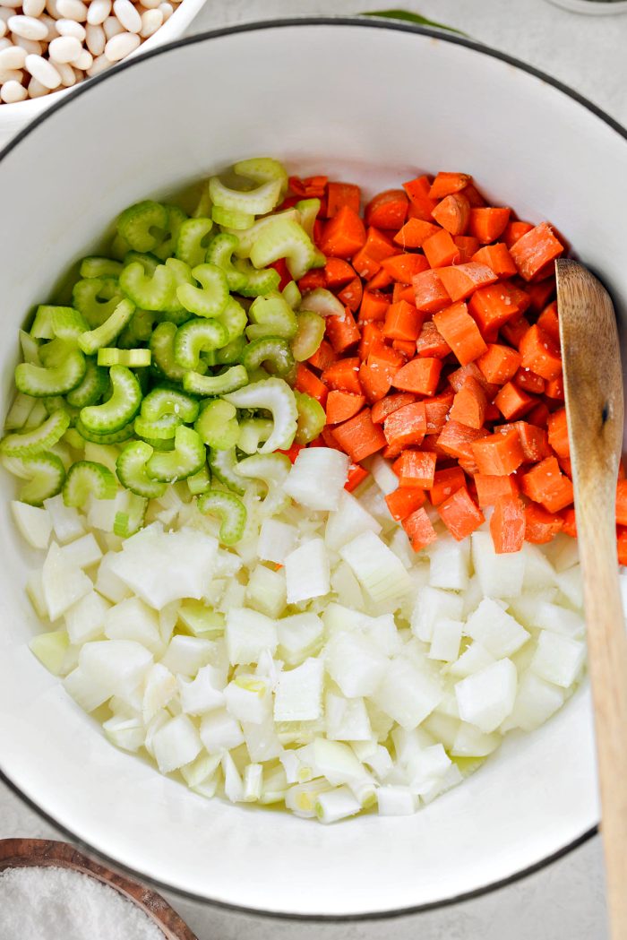 in a dutch pan add oil, carrots, celery, onion and pinch of salt