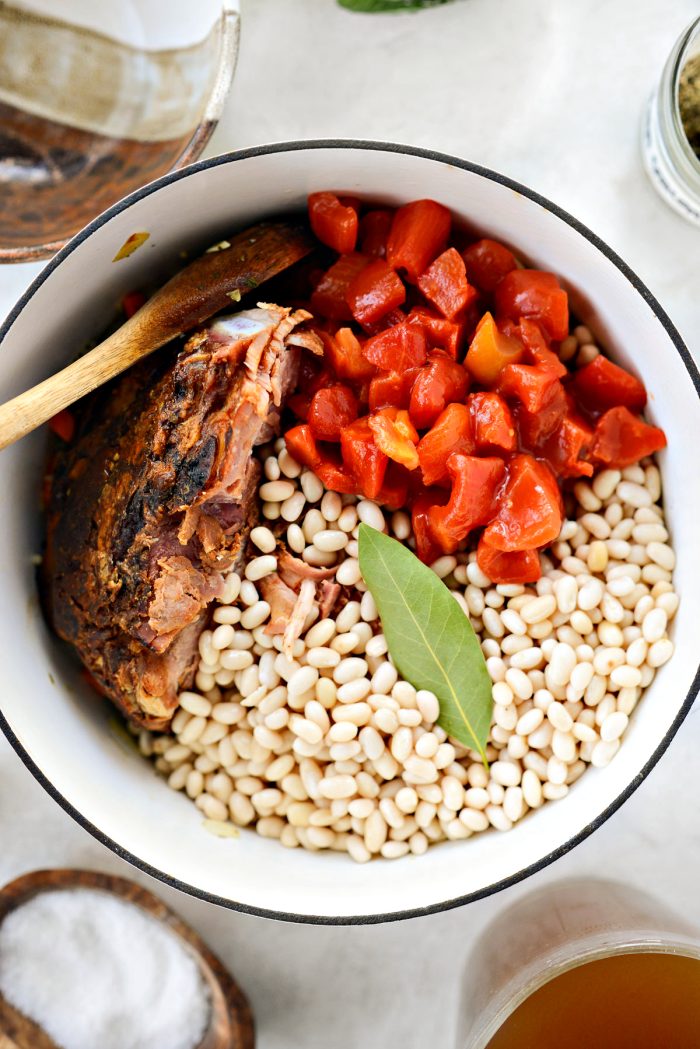 drain, rinse and add beans to pot with tomatoes, ham bone and bay leaf