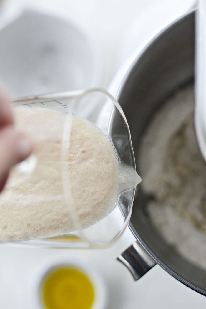 pour yeast mixture into mixer with dry ingredients