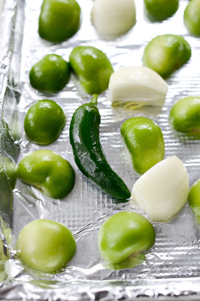 tomatillos, Jalapeno and onion on lined sheet pan before broiling