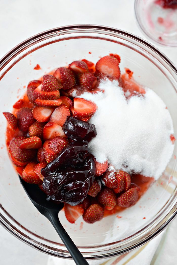 add jam and sugar to strawberries