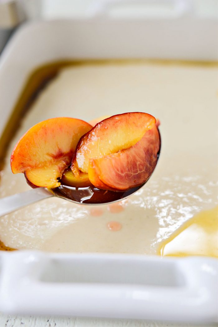 spoon peaches overtop of batter and brown butter