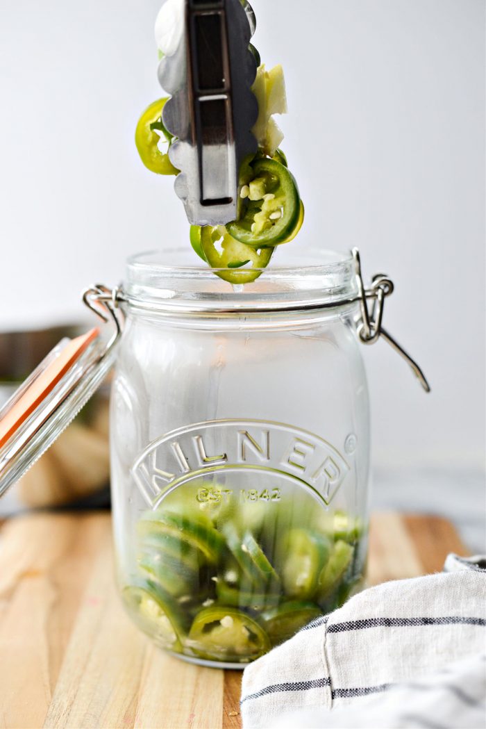 use tongs to transfer jalapenos to jar