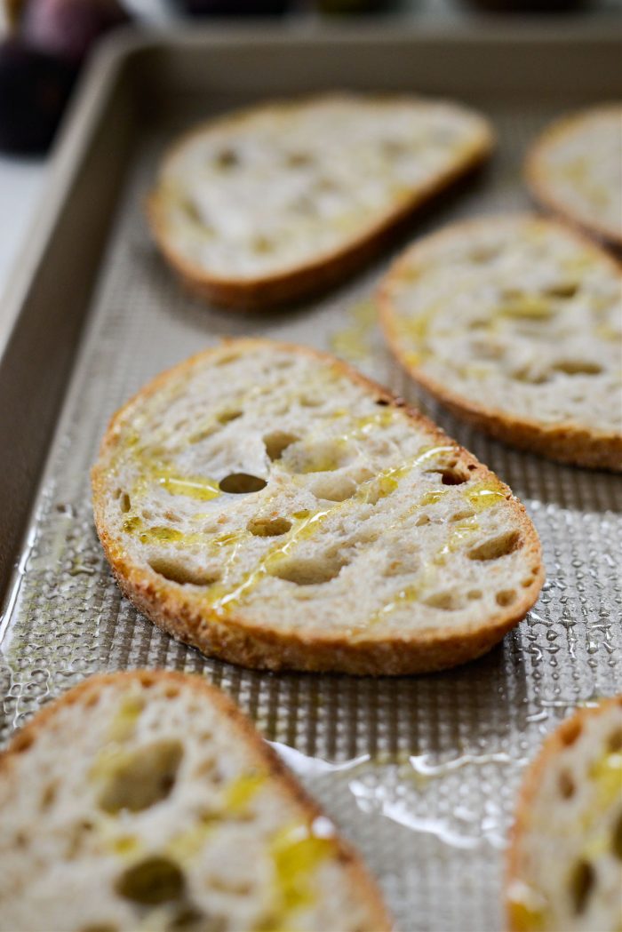 baking sheet of sliced bread with olive oil 