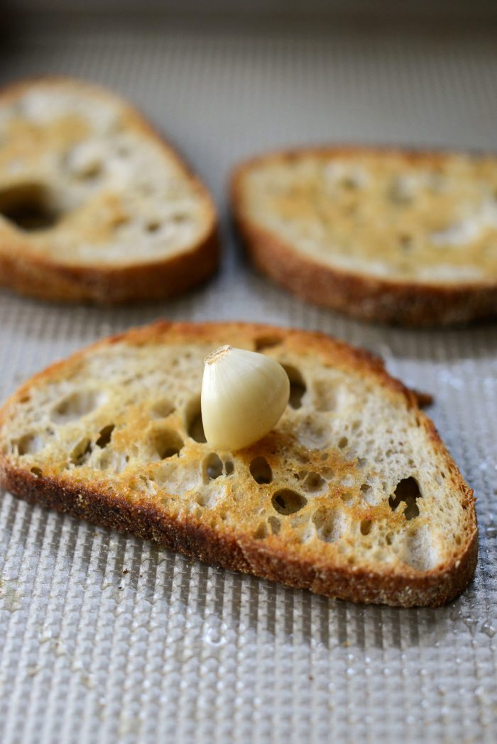 rubbing garlic on toasted bread