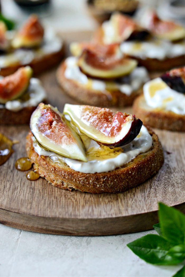 Top bread with burrata, quartered figs and honey