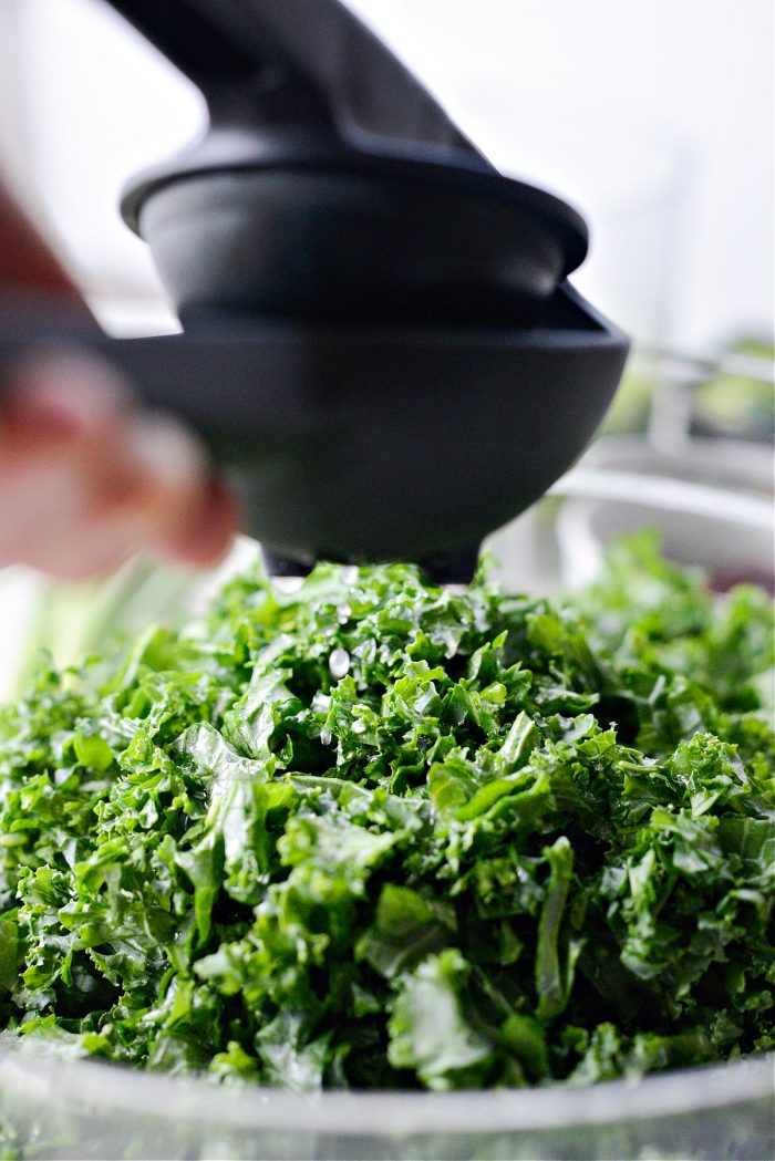 squeezing lemon on kale