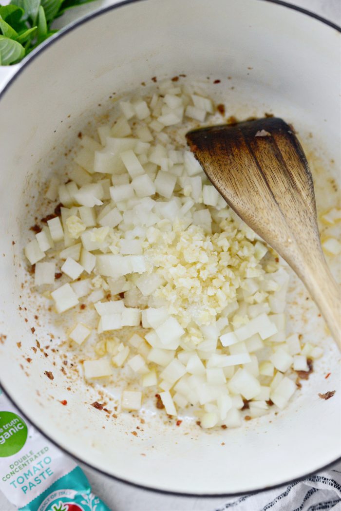 onions and garlic in pot with sausage fat