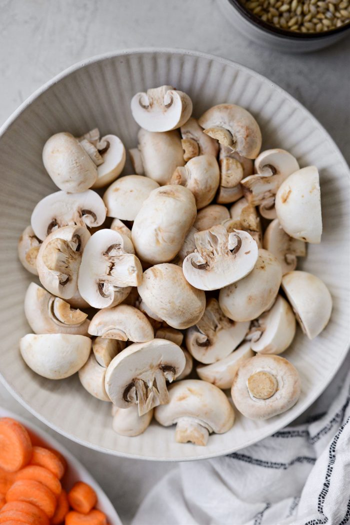 halved button mushrooms in a bowl