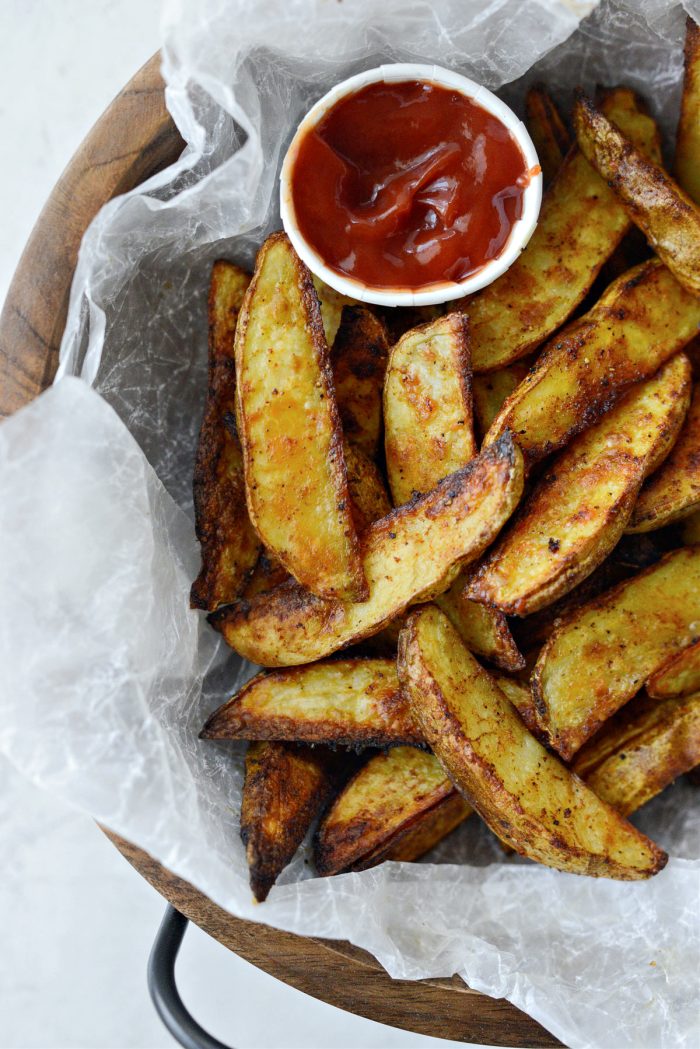 Seasoned Steak Fries in bowl with a side of ketchup