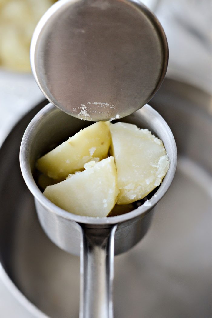 add cooked potatoes to a ricer