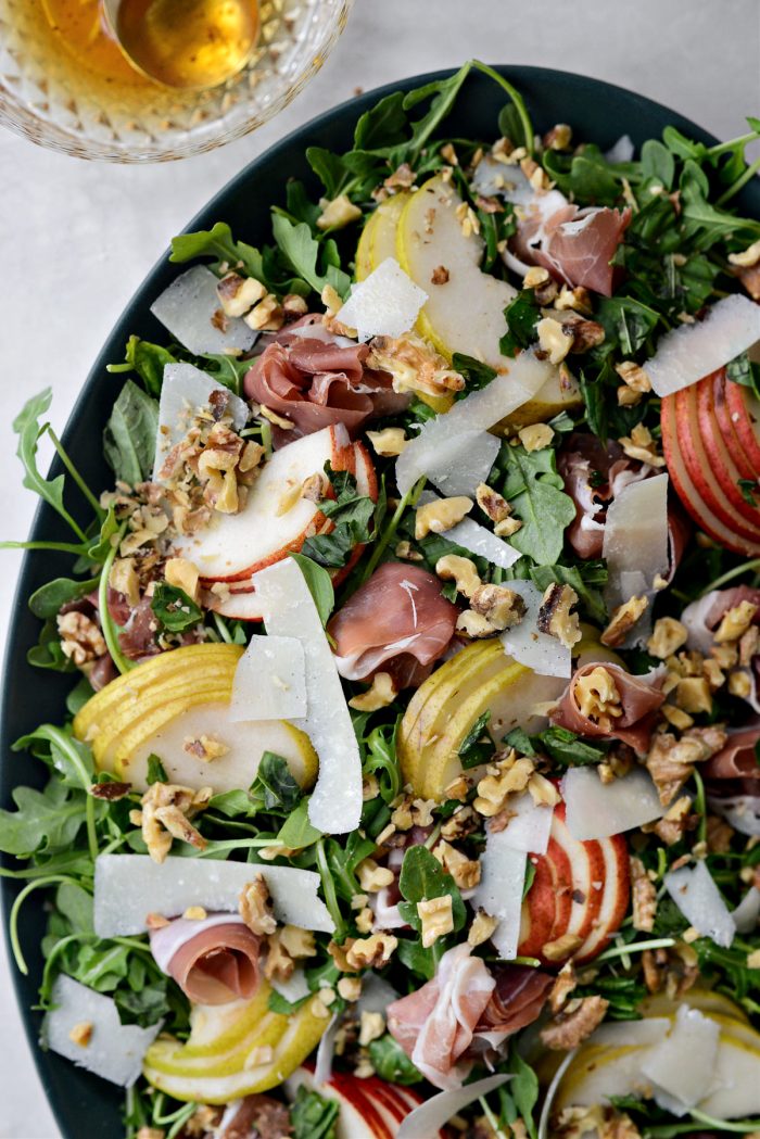 top with torn basil, pears, prosciutto parmesan shavings and walnuts