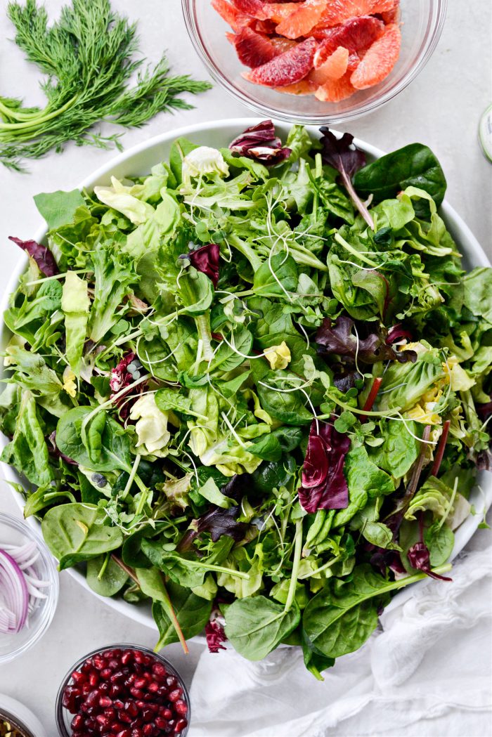 add salad greens to a large platter or individual bowls