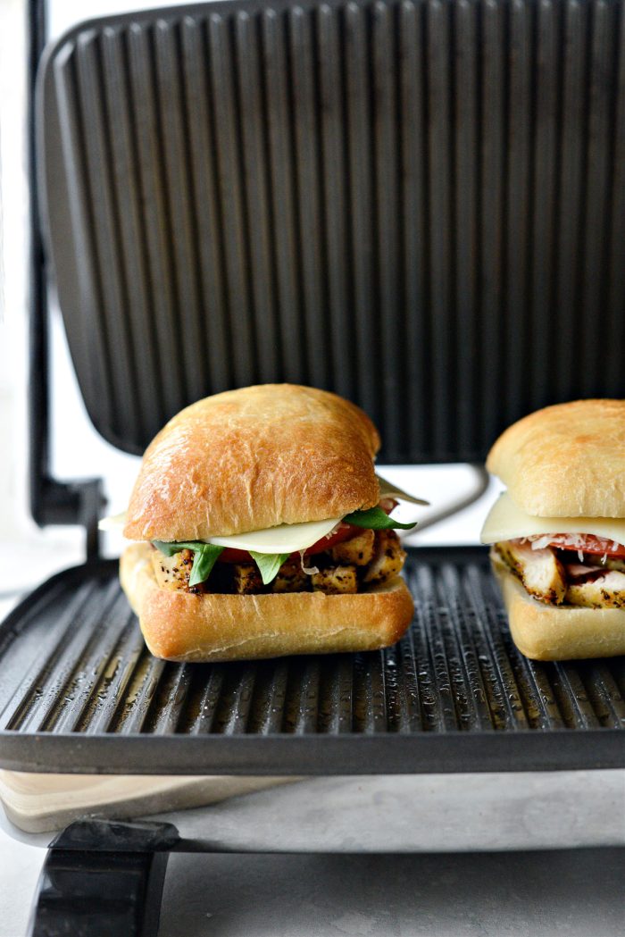 spray tops of ciabatta rolls and place on preheated press