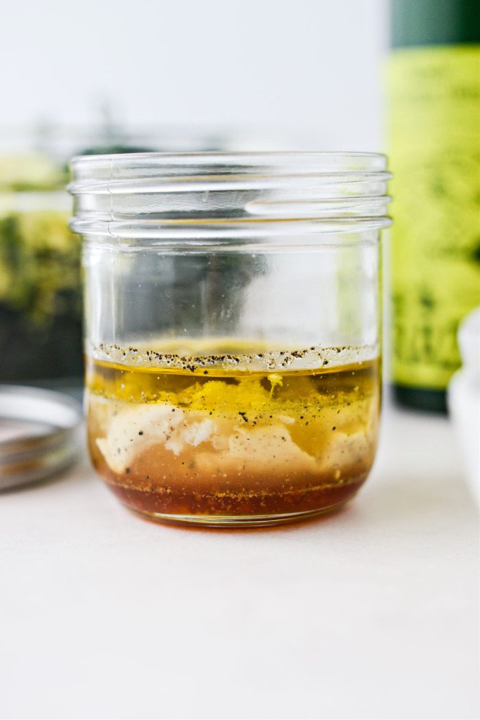 Ingredients for hot honey dijon vinaigrette in jar