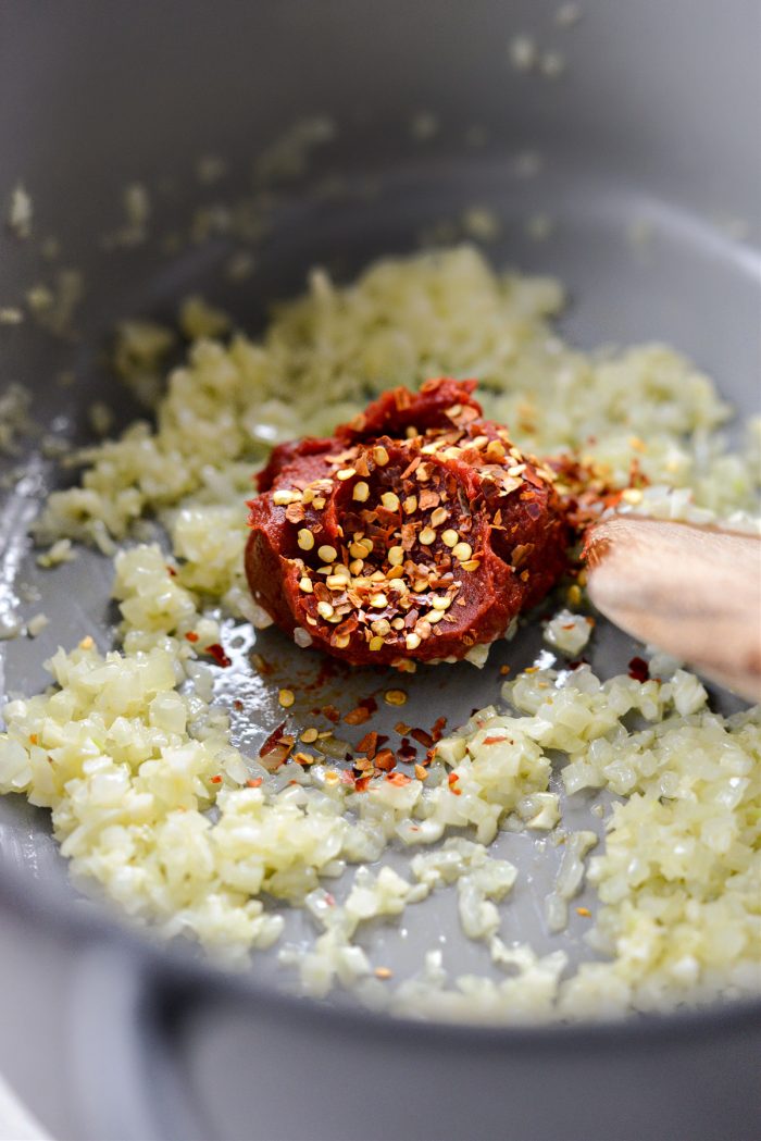 Add tomato paste and chili flakes