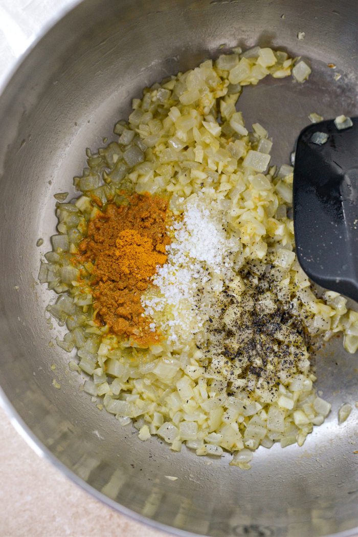 Add turmeric, salt and freshly ground black pepper