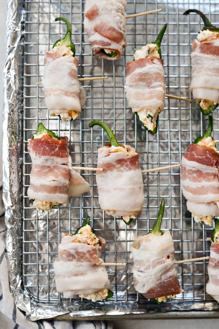 wrap jalapenos with half a piece of bacon