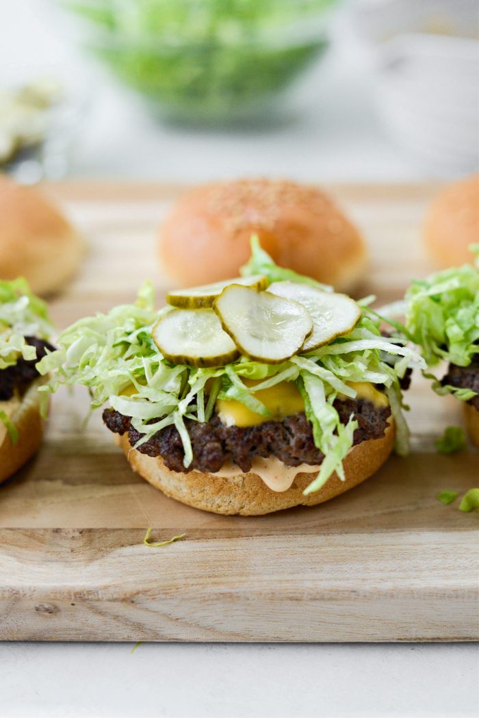 burger patty, shredded lettuce and sliced pickles