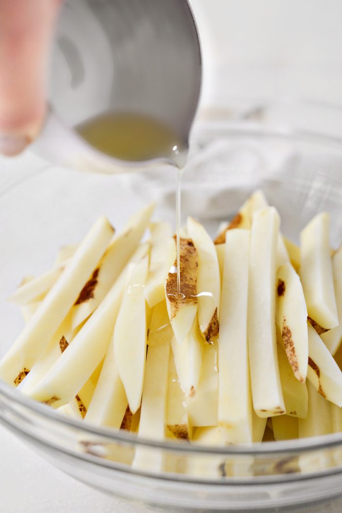 add to a bowl and toss in oil