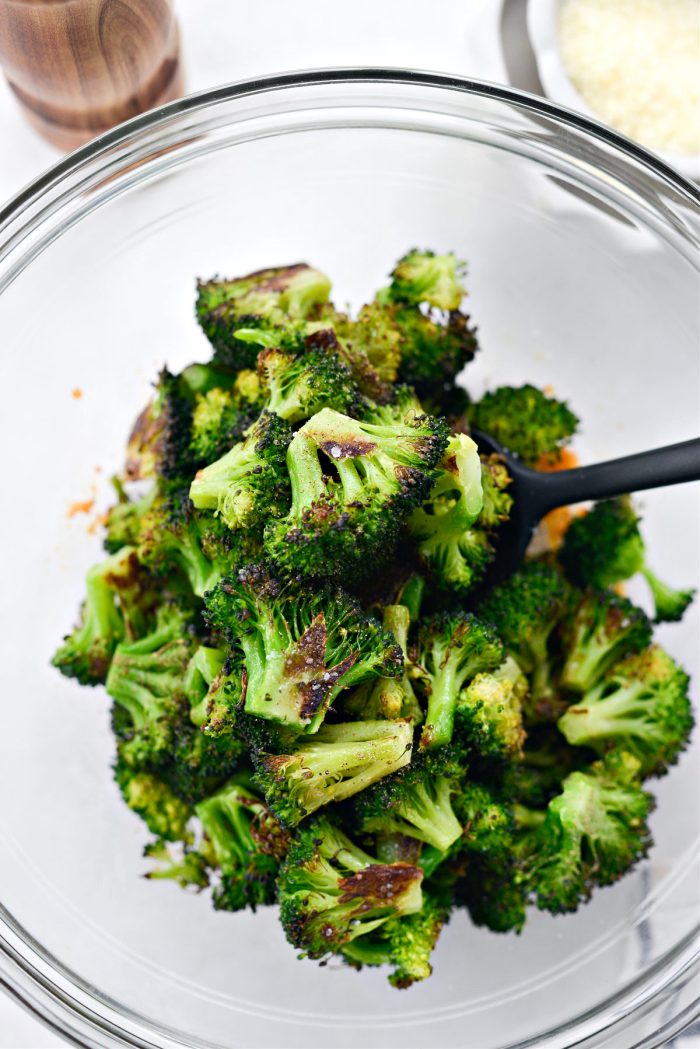 add broccoli to the bowl with the chili crunch and parmesan.