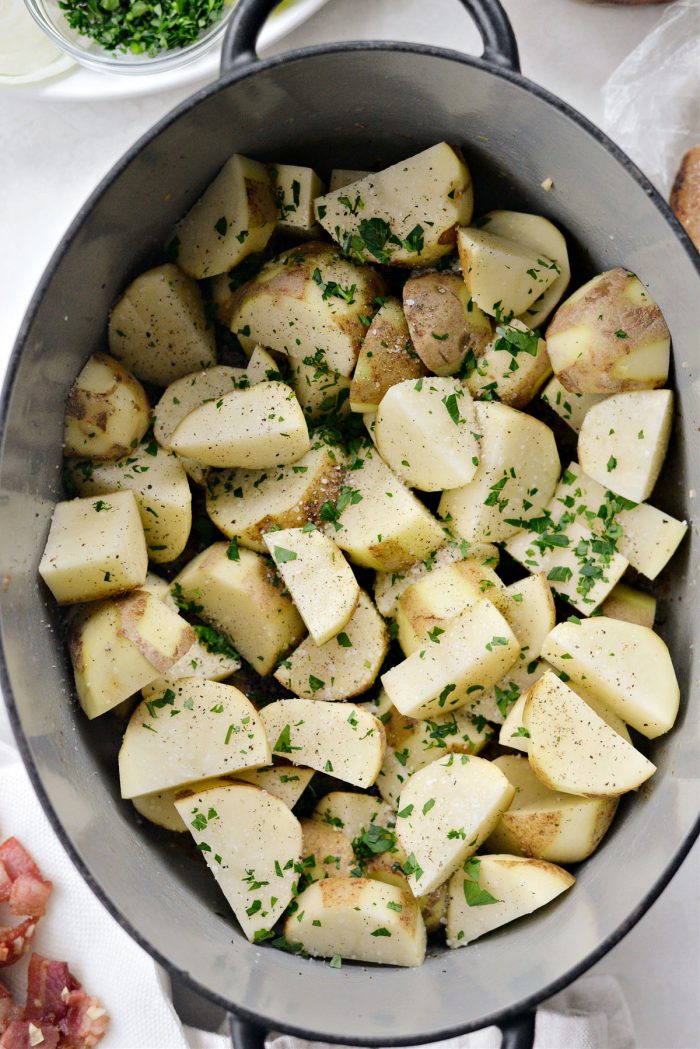 Add potatoes to pot and season with salt, pepper and 1/2 of the parsley.