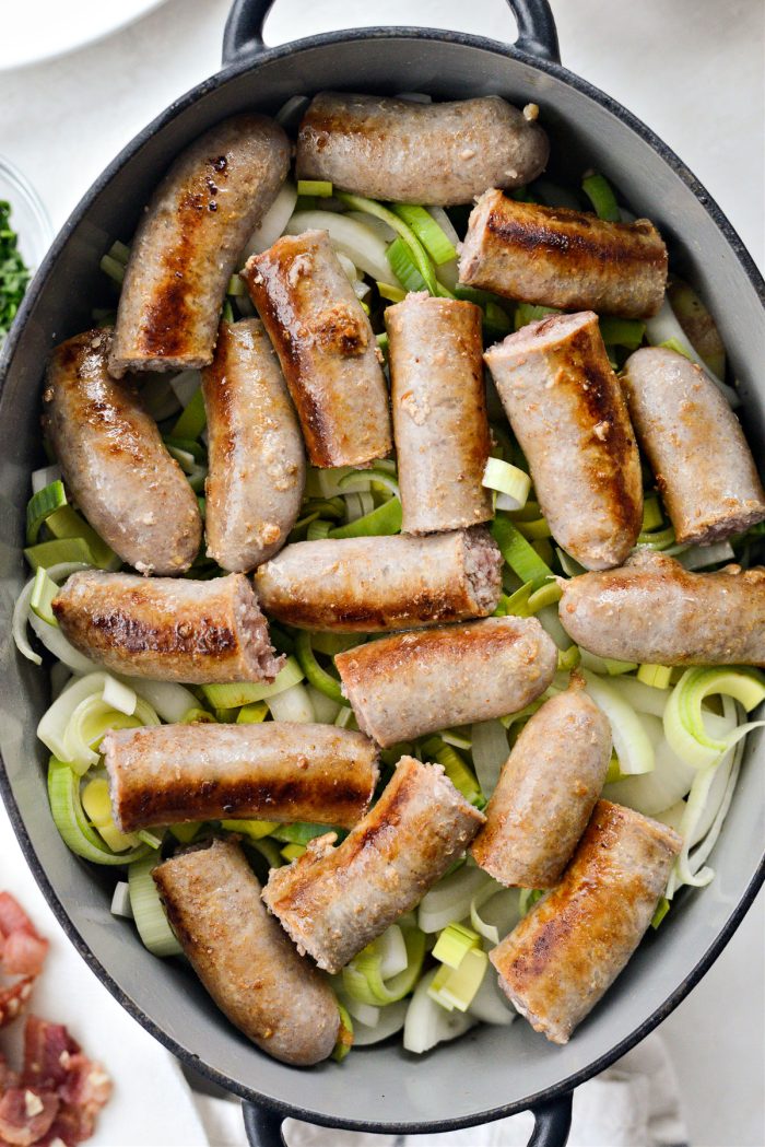 Next add onions, leeks and sausages.