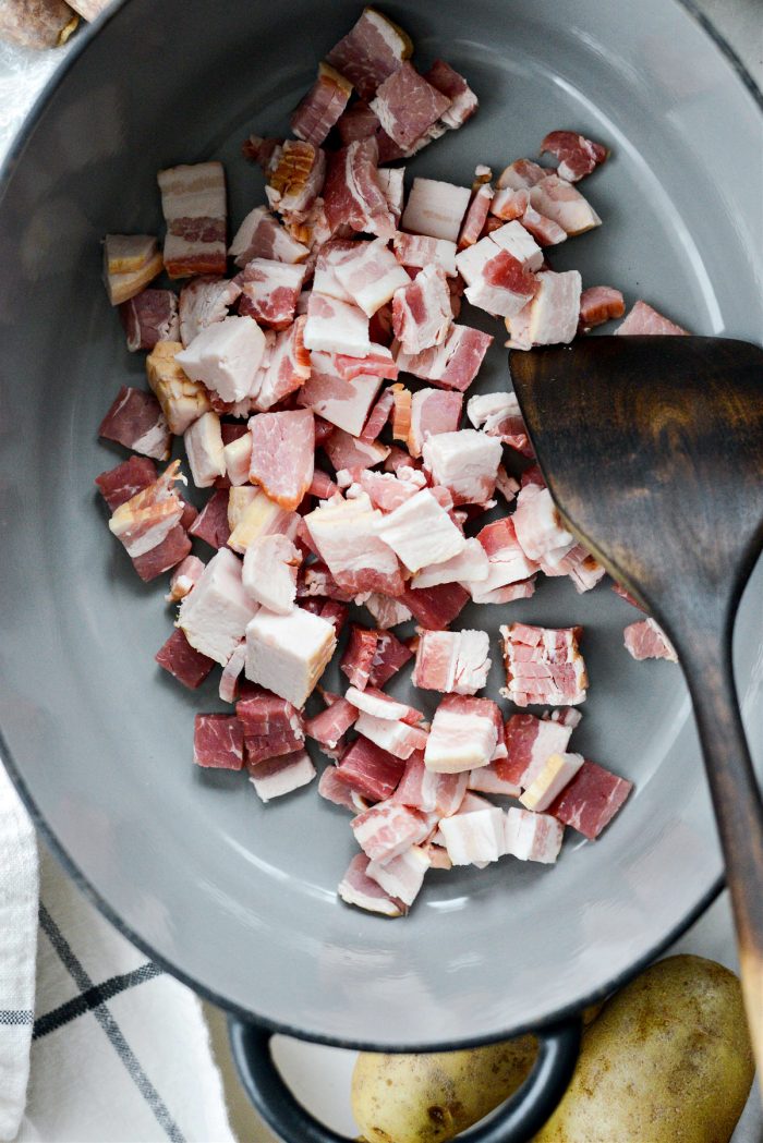 Place bacon cubes in a Dutch oven.