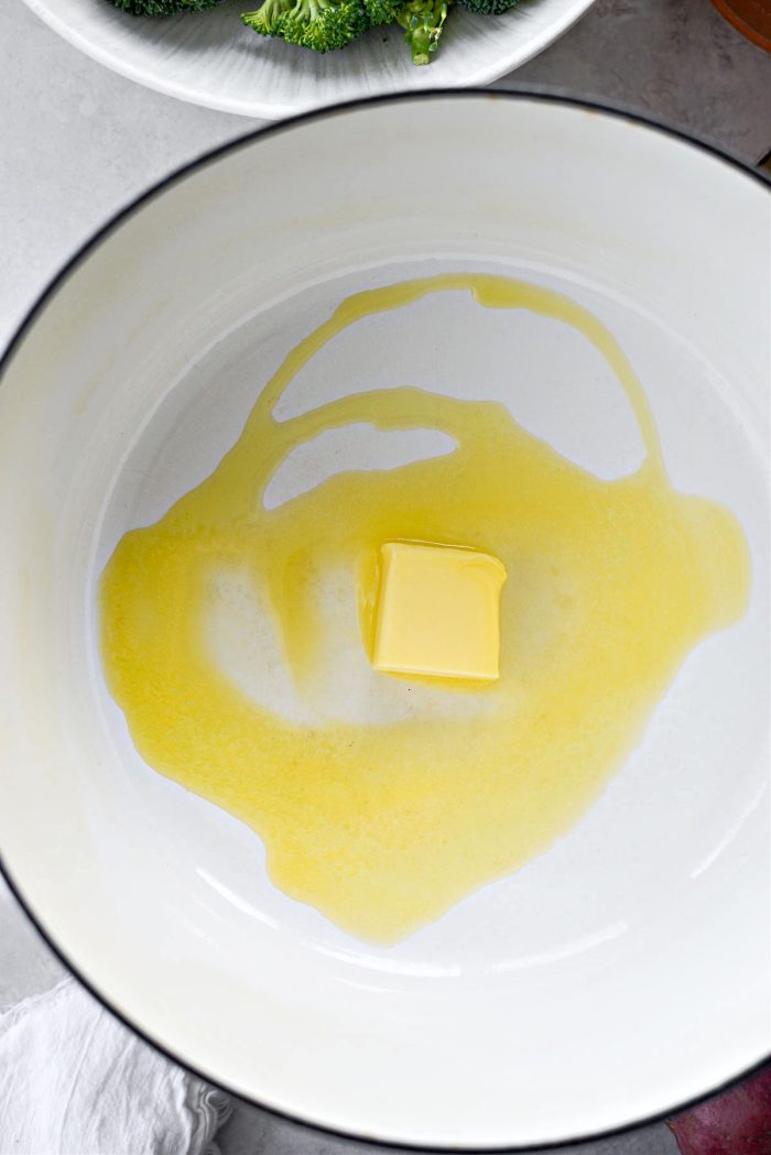 Melt butter with oil in a Dutch oven.