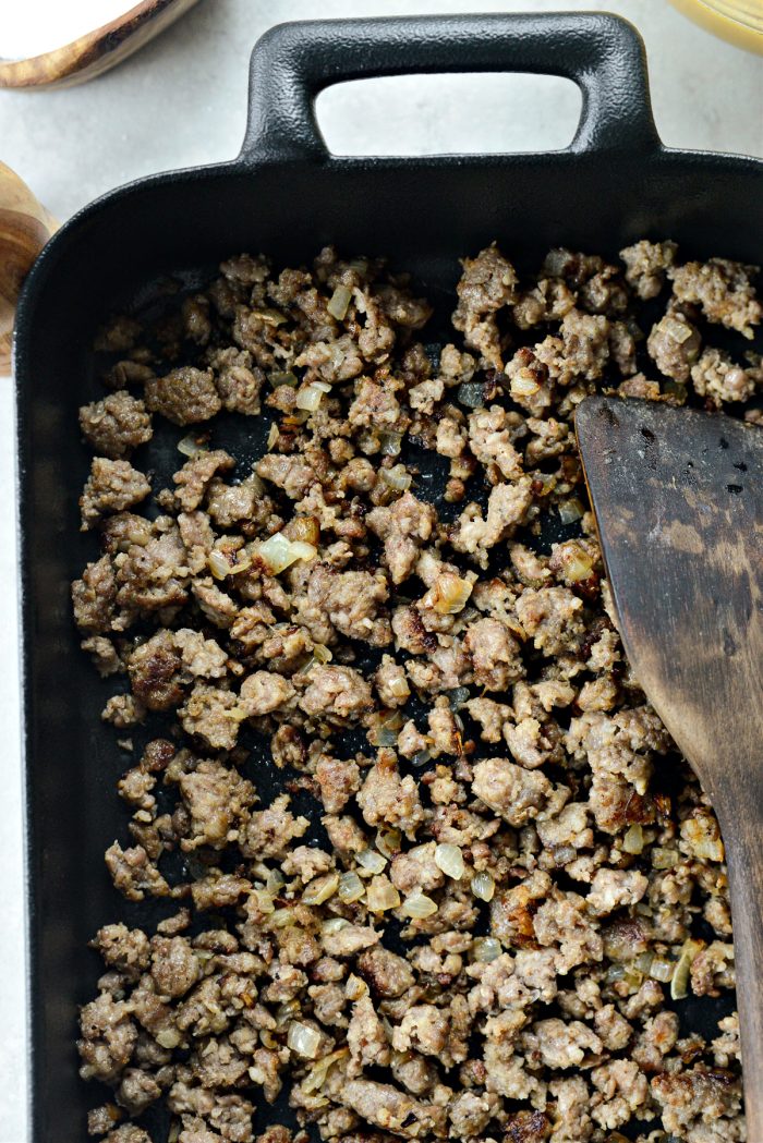 Add crumbled browned breakfast sausage to prepared pan.