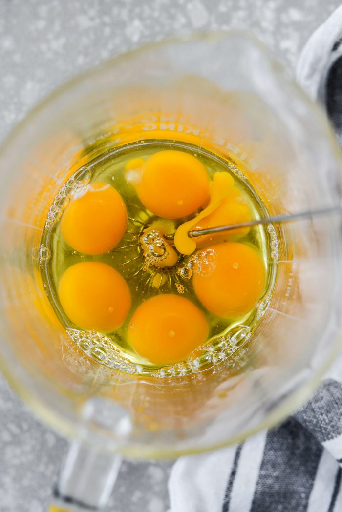 crack 6 eggs into a bowl or liquid measuring cup.