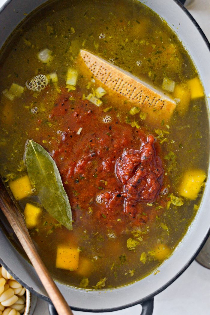 add broth, fire-roasted tomatoes, parm rind and bay leaf