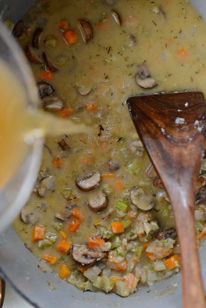 pour in broth and water