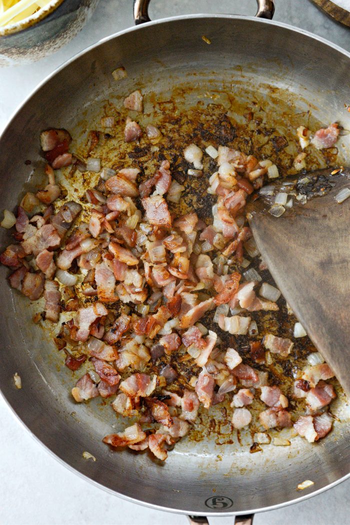 crispy bacon and tender shallots in skillet.