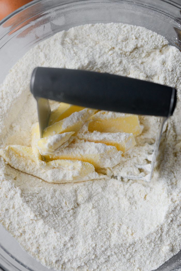 large mixing bowl with yellow cake mix and unsalted butter.