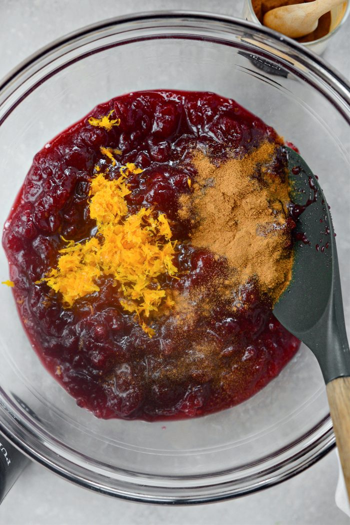 cranberry sauce, orange zest and cinnamon in a bowl.