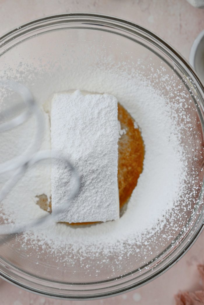 add heavy cream, vanilla, cream cheese and sifted powdered sugar to a bowl.
