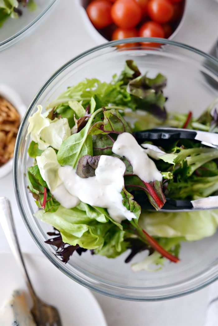 toss salad greens with dressing
