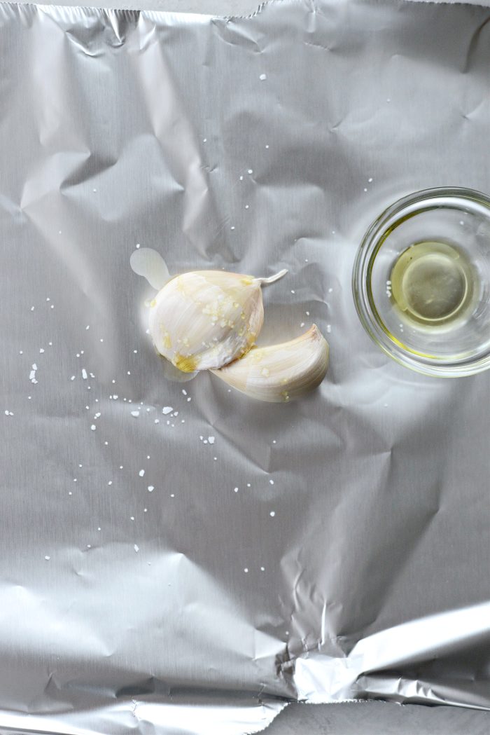 unpeeled garlic, oil and salt on foil