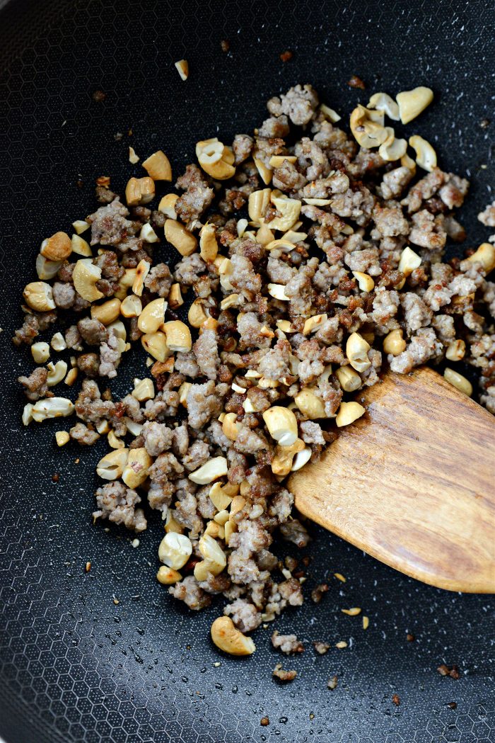 Add chopped cashews to wok